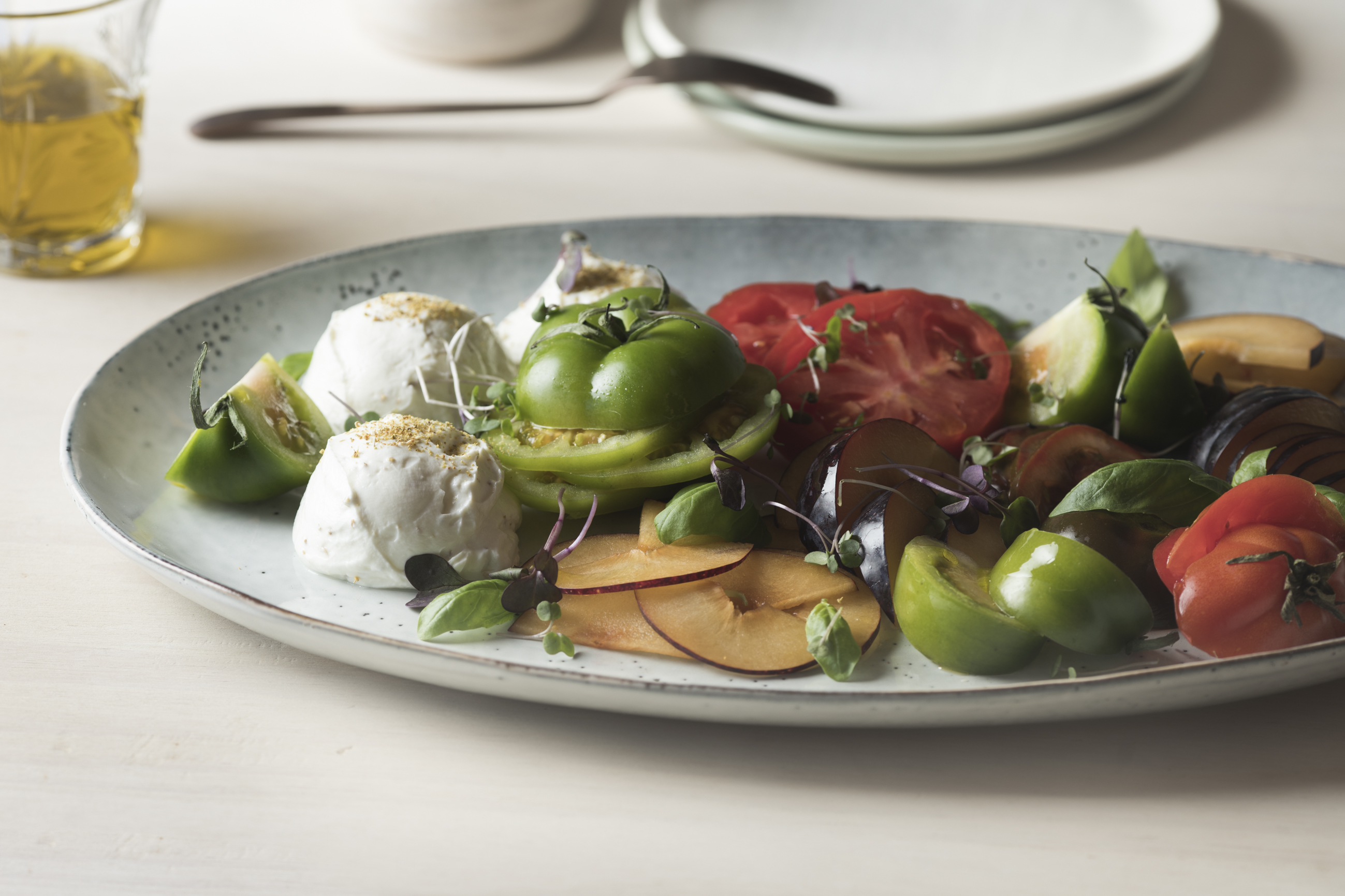 Heirloom tomato caprese w/ dark plums & fennel pollen labneh